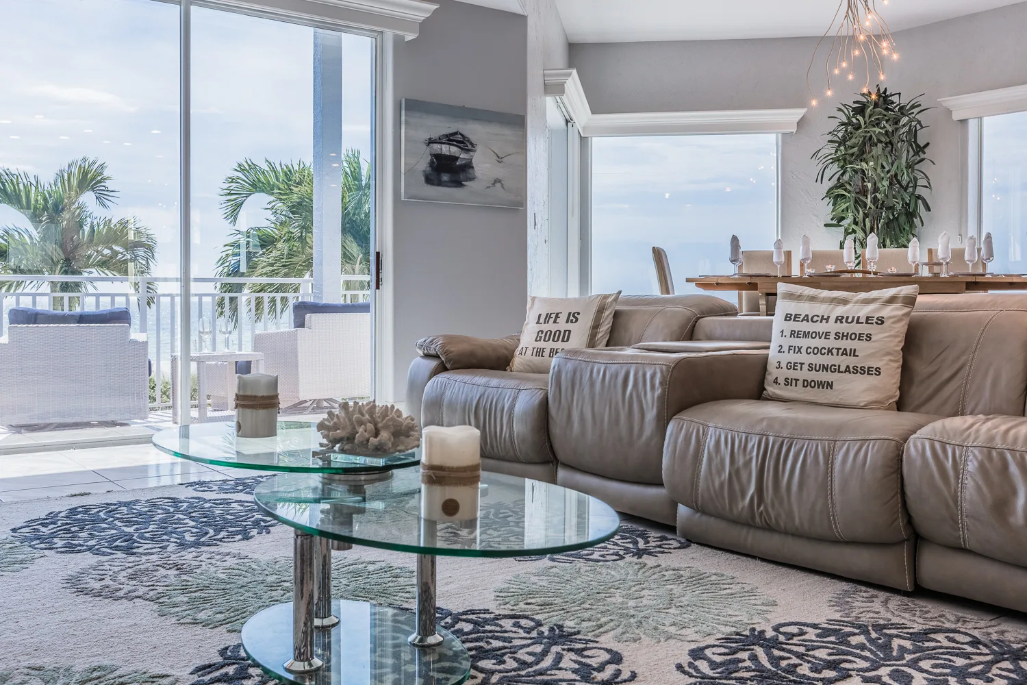 Living room with tiered glass coffee table and ocean-view windows