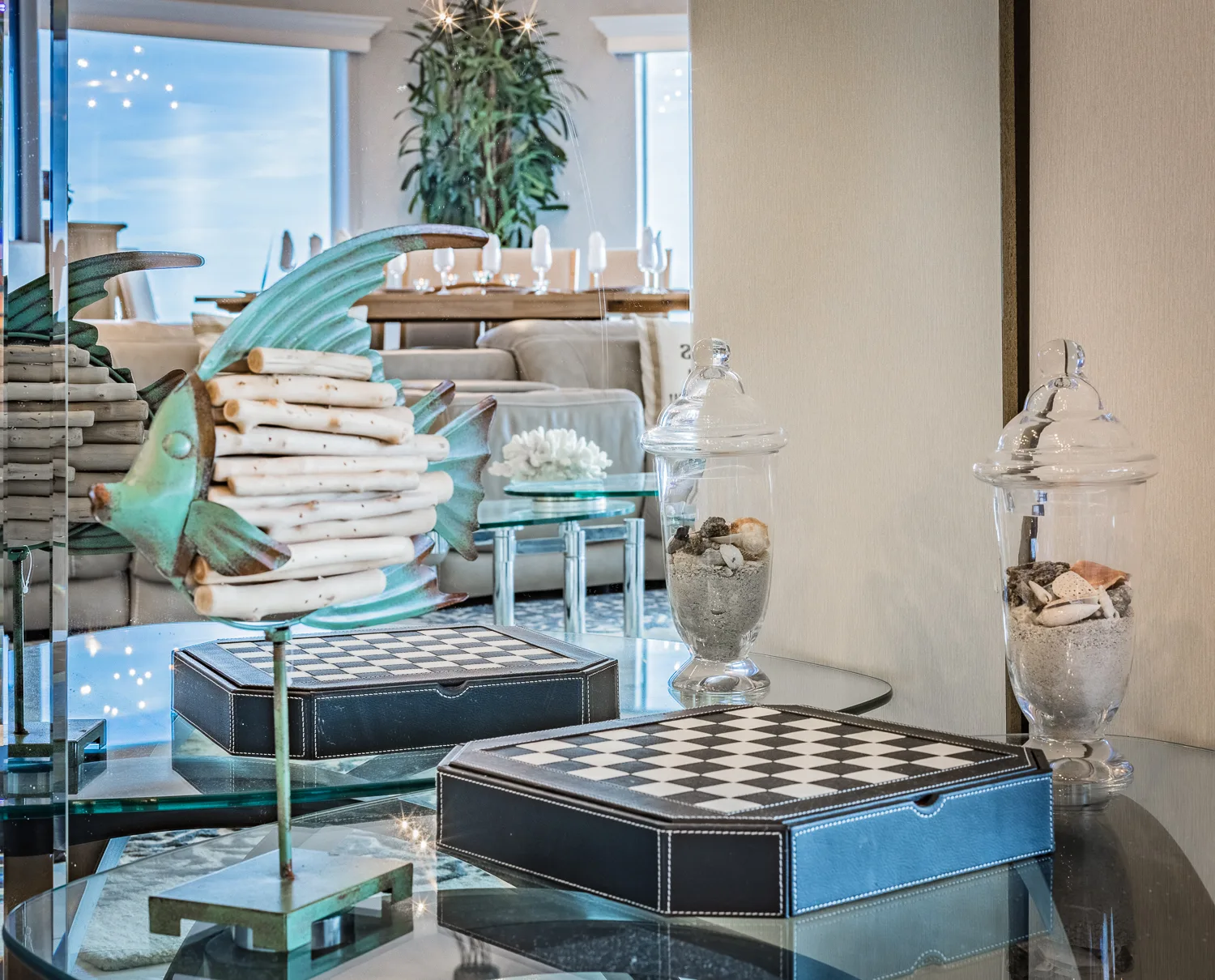 Decorative fish sculpture and chessboard on a glass table in living area