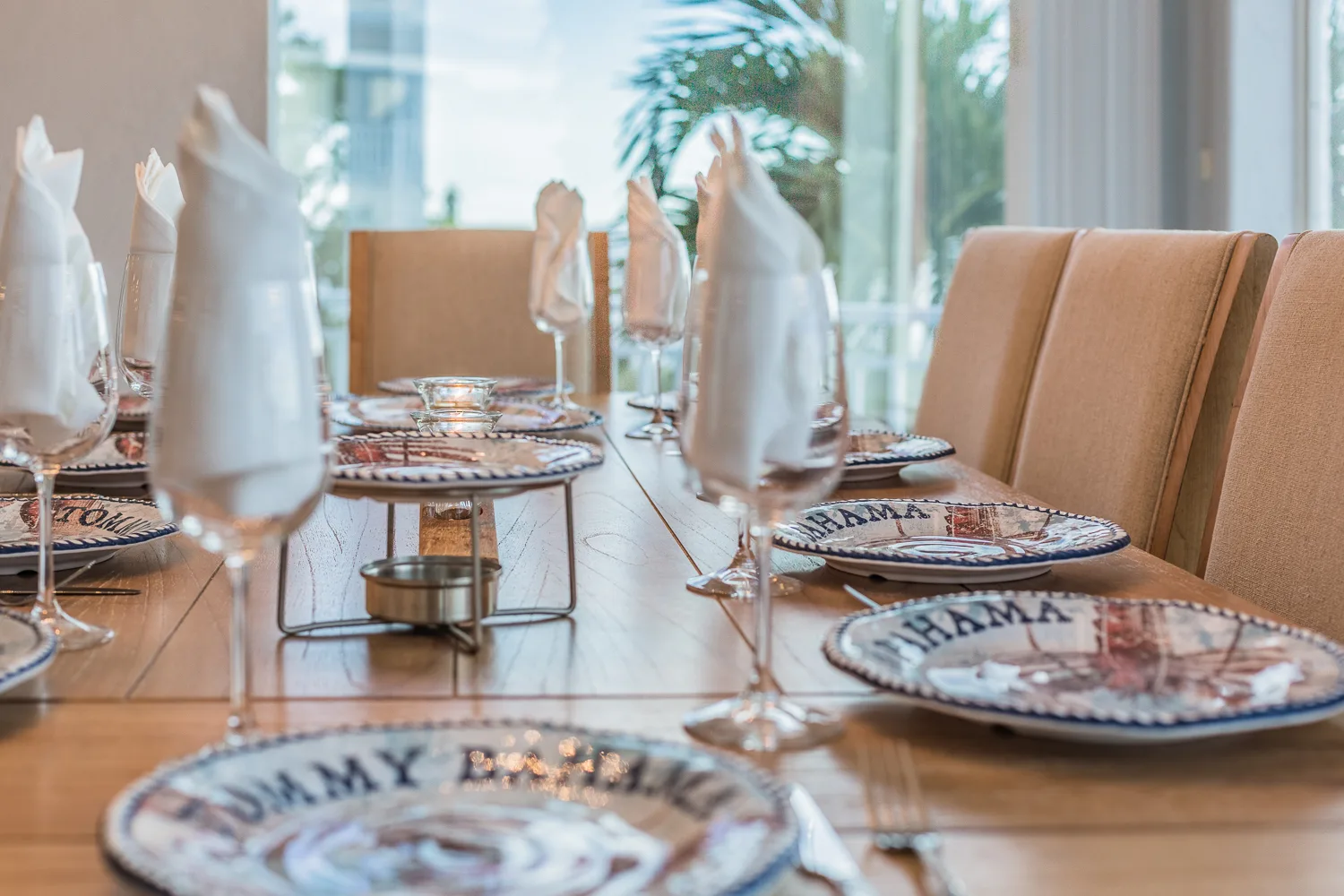 Close view of place settings with folded napkins and patterned plates