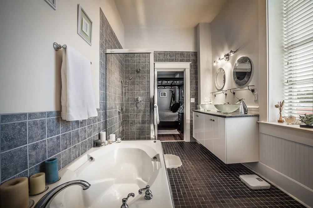Bathroom with deep soaking tub, slate tile walls and glass shower