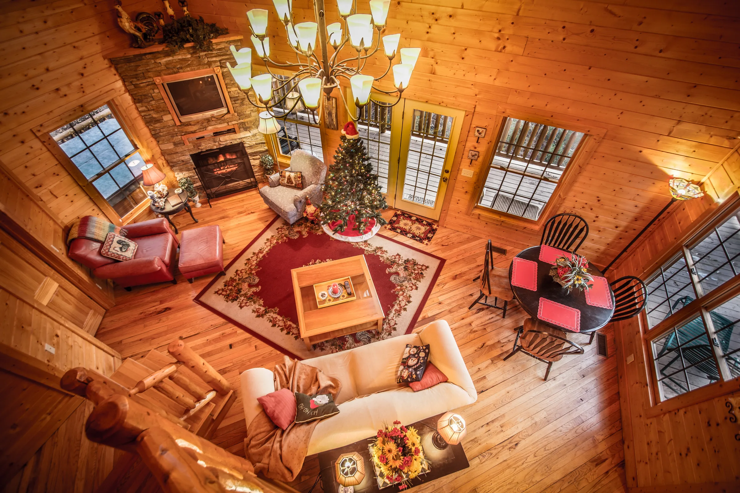Overhead view of cabin living room with fireplace and holiday decor
