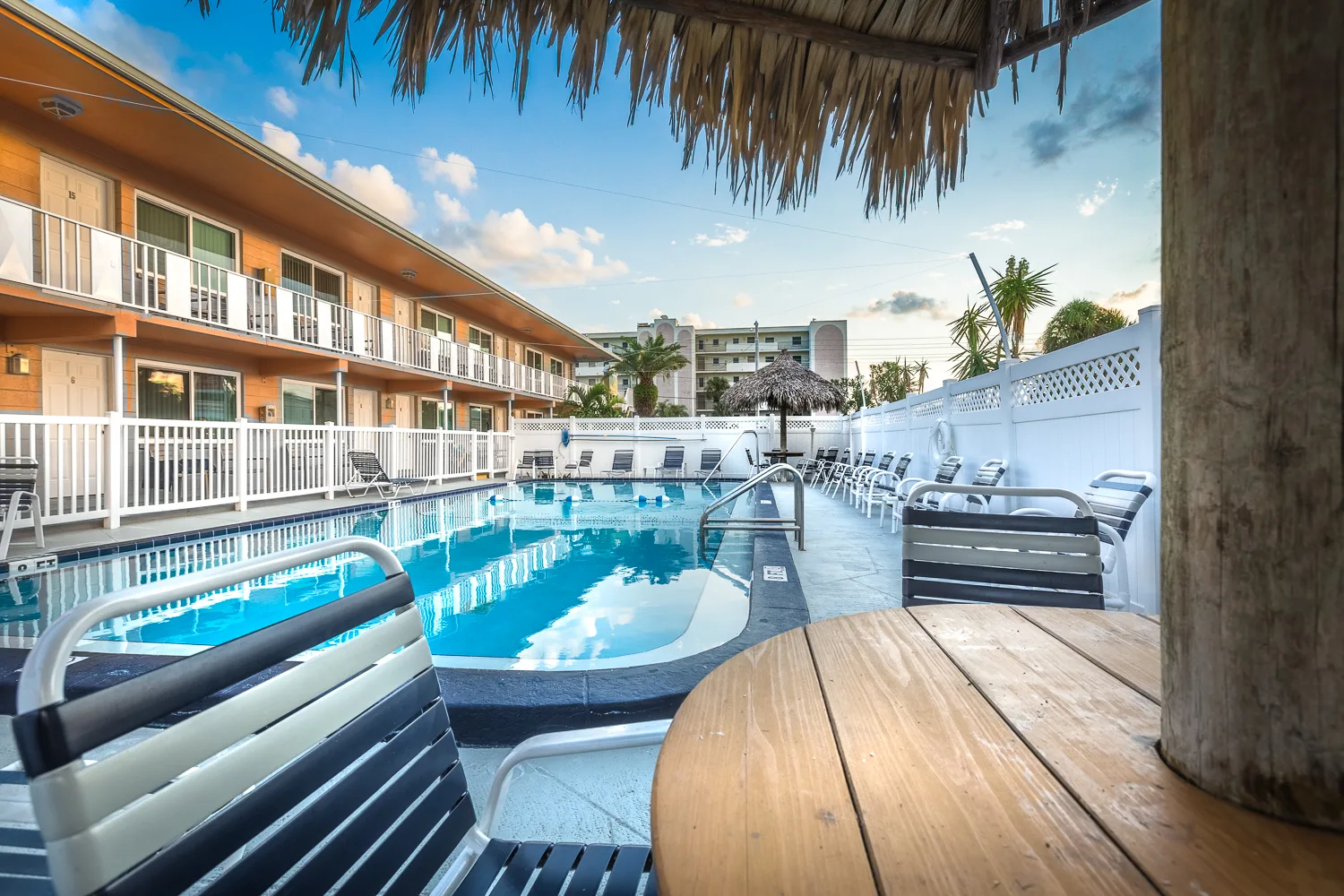 View from a thatched tiki hut across the courtyard swimming pool
